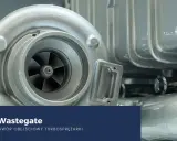 Turbosprężarka z widocznym wirnikiem i obudową. Tekst: "Zawór Wastegate - jak działa zawór obejściowy turbosprężarki".