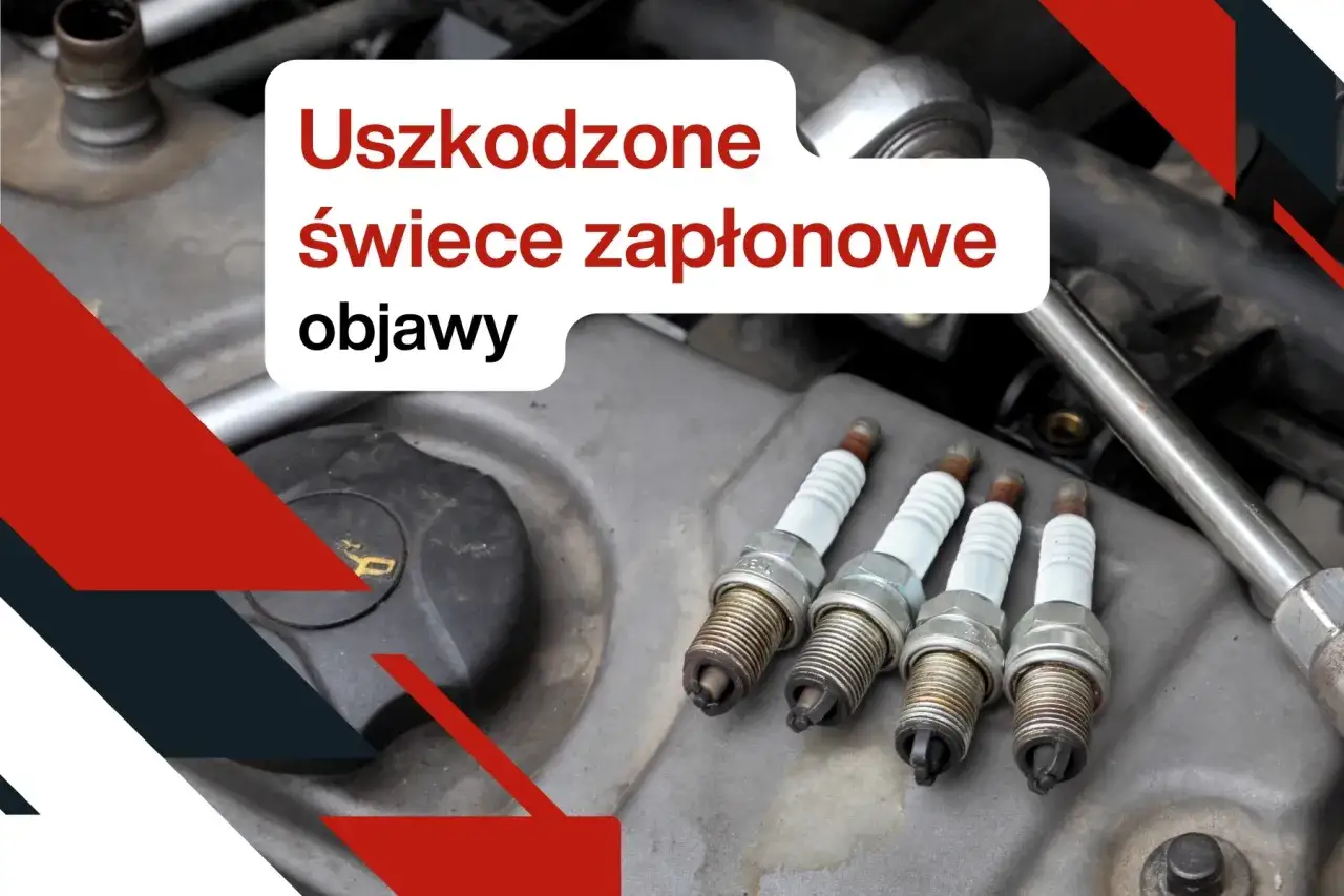 Uszkodzone świece zapłonowe objawy: cztery zużyte świece zapłonowe leżą na silniku samochodu, gotowe do wymiany.